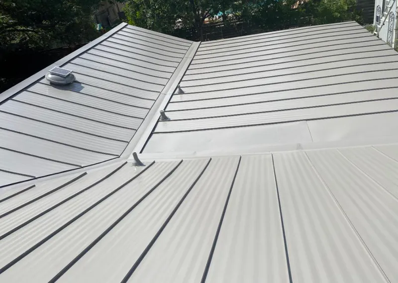 Solar attic fan installed on a metal roof for Roof Ventilation in Waunakee